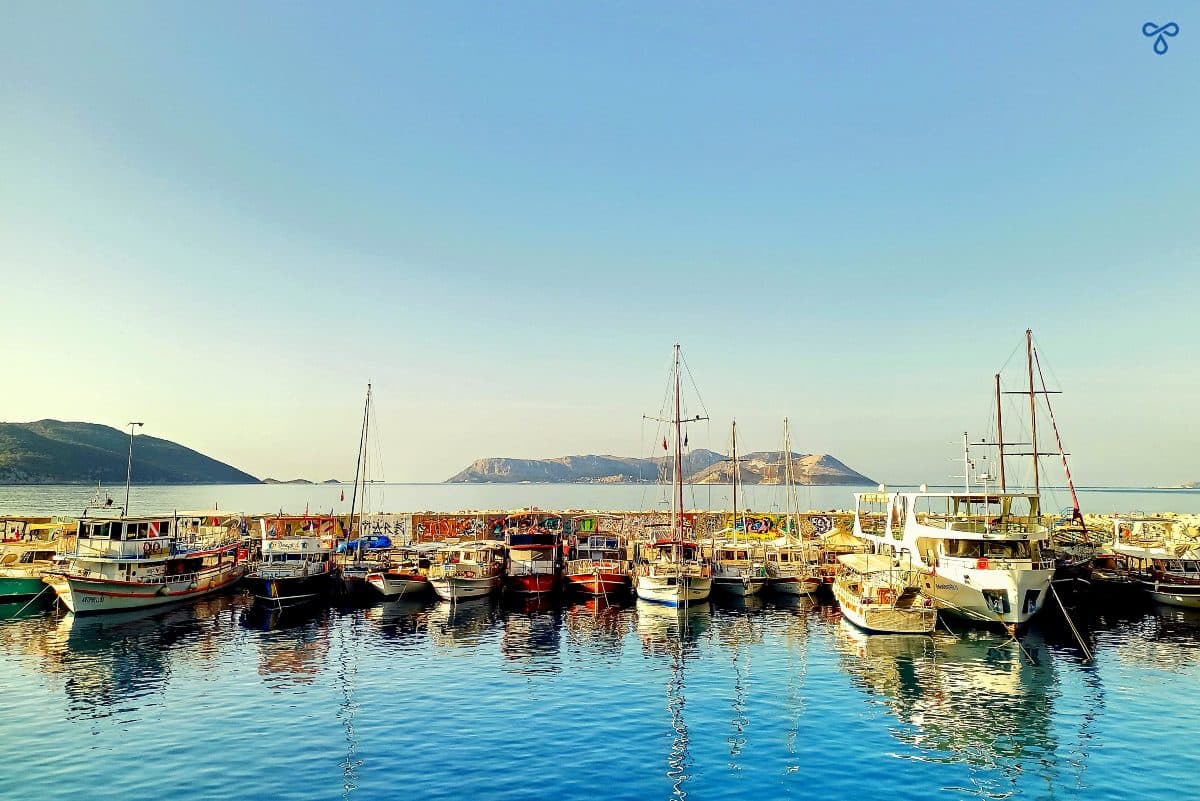 A row of yachts in Kaş harbour with Meis Island in the background.