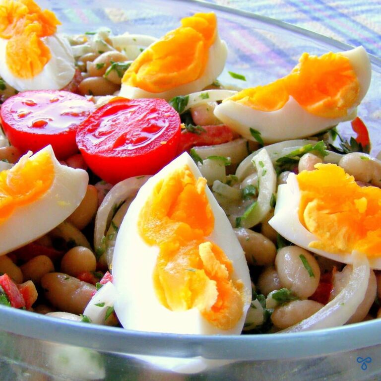 White bean salad with cherry tomato, sliced onion and sliced, har boiled eggs