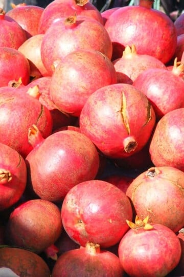 A pile of pomegranates on a market stall