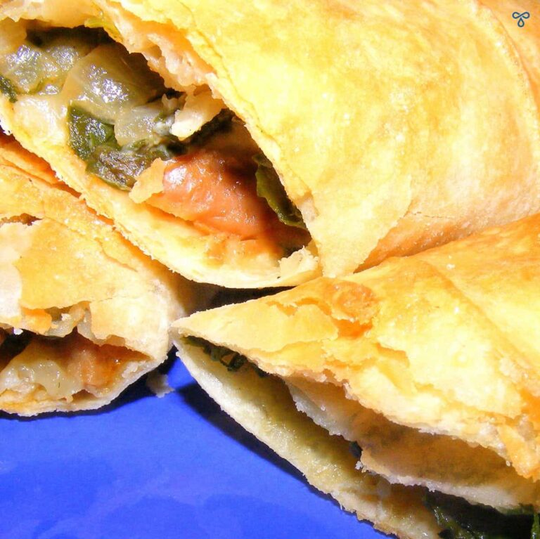 Börek rolls cut in half to reveal a spinach and mushroom filling