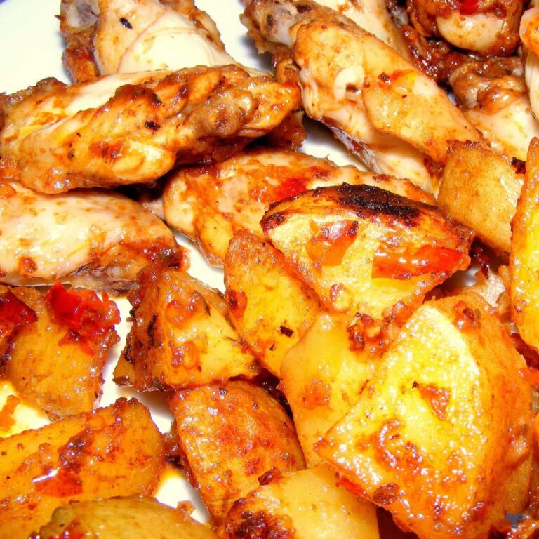 Roasted potatoes and chicken wings on a plate