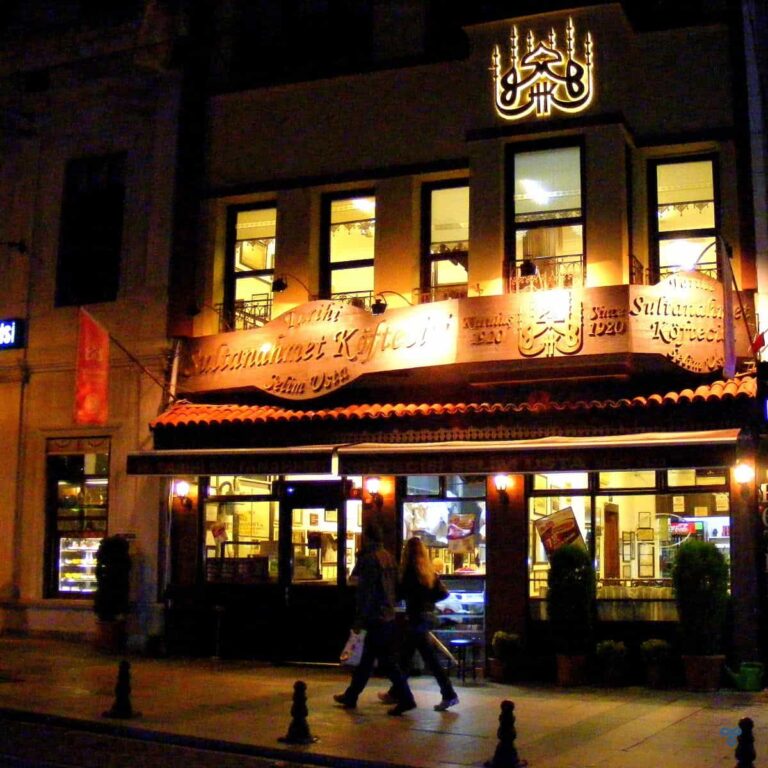 A nighttime photo of a restaurant frontage.
