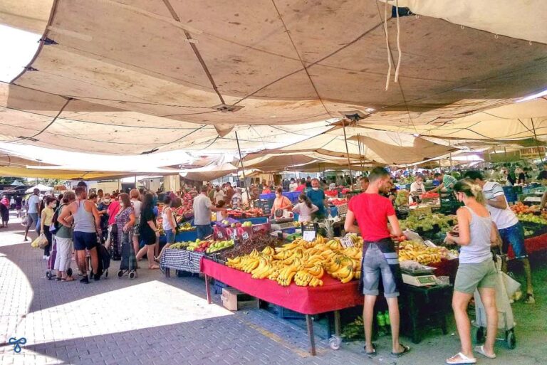 A busy Çalış Market with a stall selling bananas.