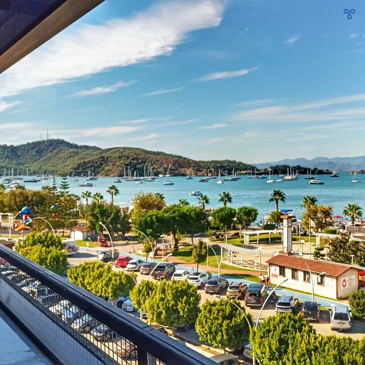 A view over Fethiye bay from the roof terrace of Cafe Park Teras. Treetops and buildings give way to the sea and yachts.