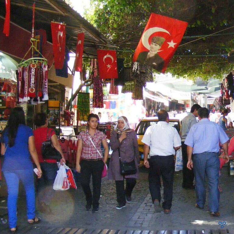 People walking through a crowded bazaar area