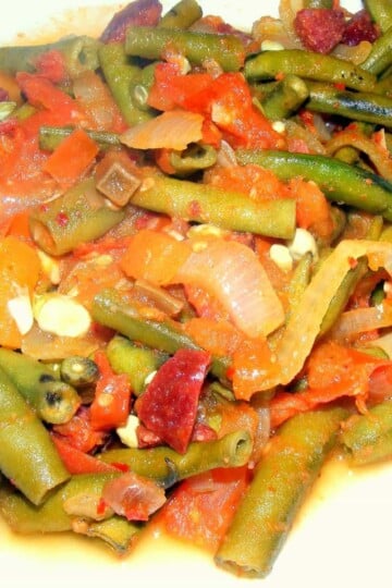 Whole baby broad beans cooked in a tomato sauce with sucuk