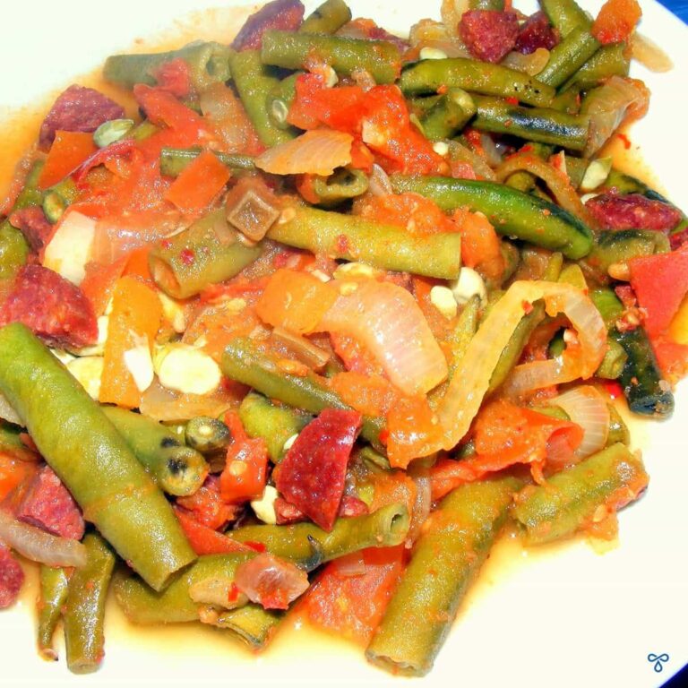 Whole baby broad beans cooked in a tomato sauce with sucuk