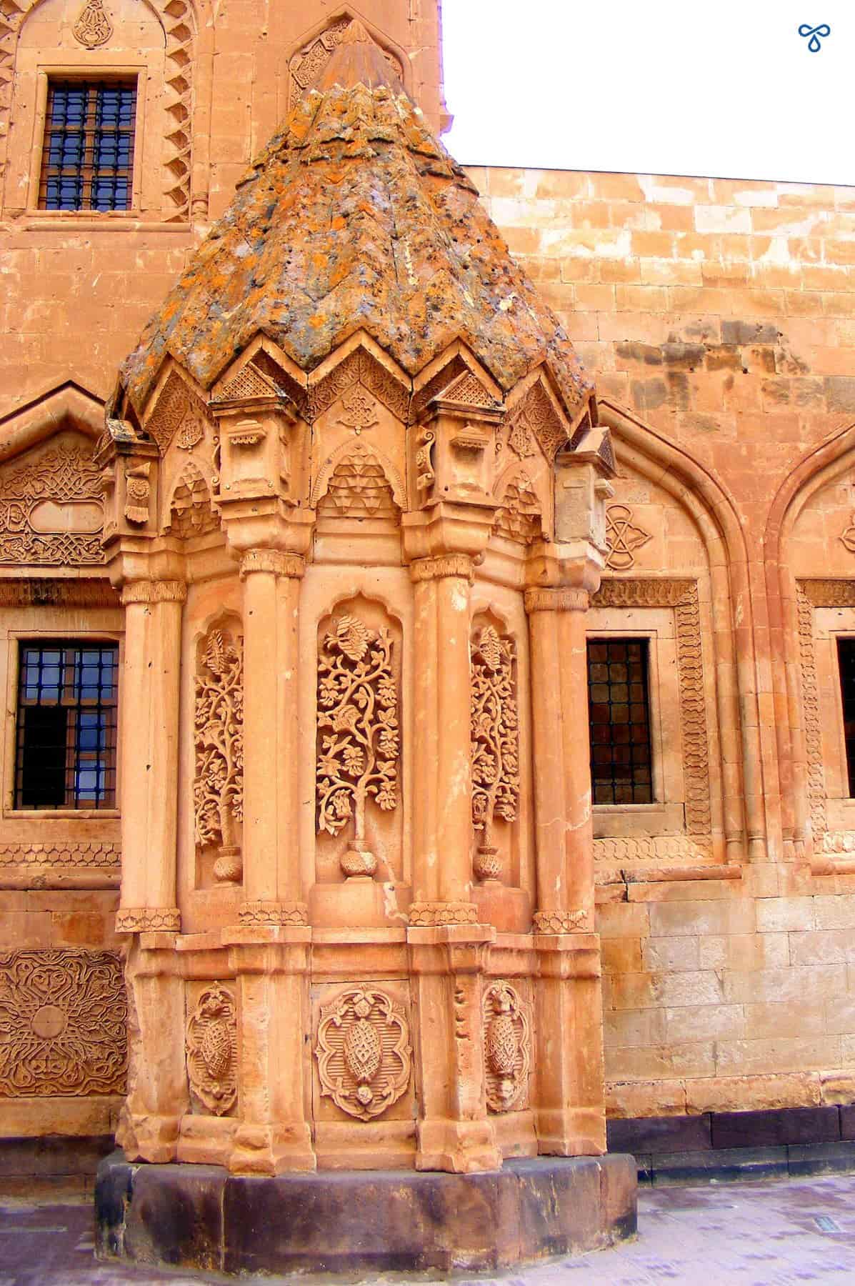 An ornate octagonal obelisk style tomb created in traditional Seljuk style. Geometric motifs are carved into the stone.