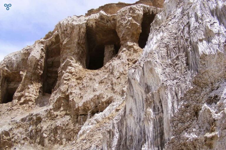 Tuzluca salt mines rock face with dried salt hanging along the surface