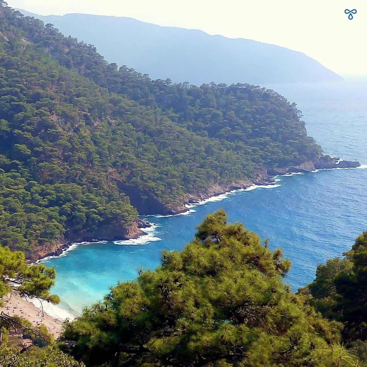 Looking down on Kabak Beach from high. The bay is backed by forested hillsides.