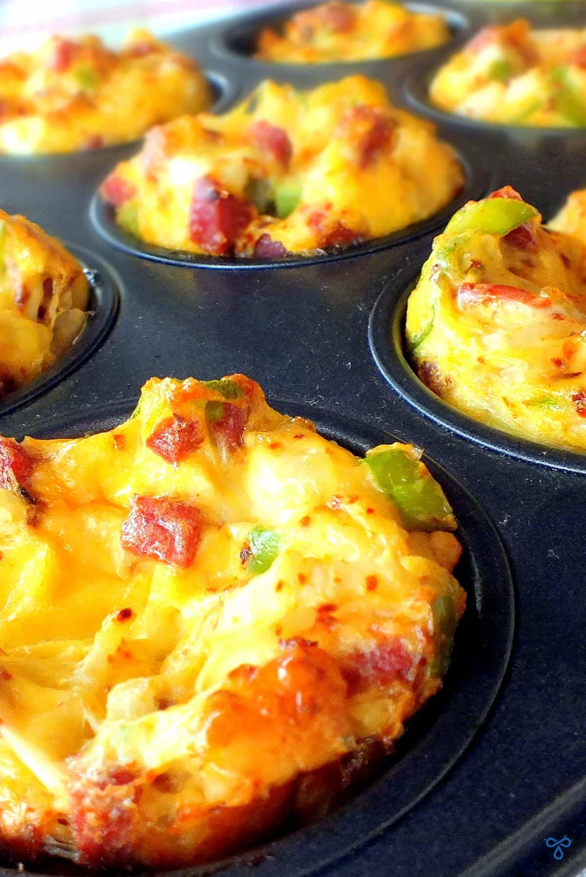 A close up of egg muffins in a muffin tin.