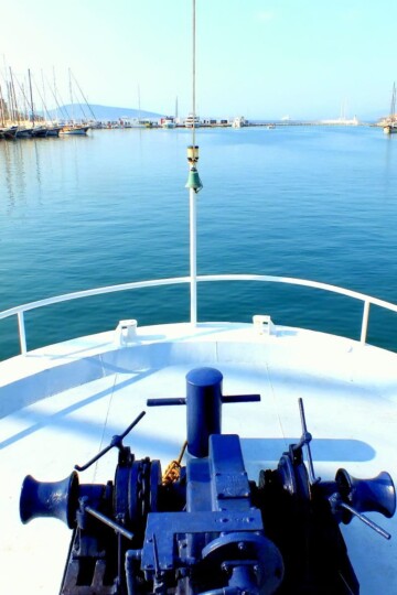 Front of a ferry heading out of Bodrum harbour. Gülets and Bodrum castle are in the distance