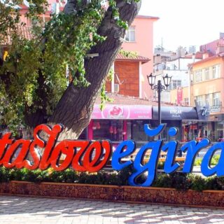 Red and blue lettering in the street spells out Cittaslow Eğirdir