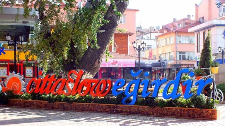 Red and blue lettering in the street spells out Cittaslow Eğirdir