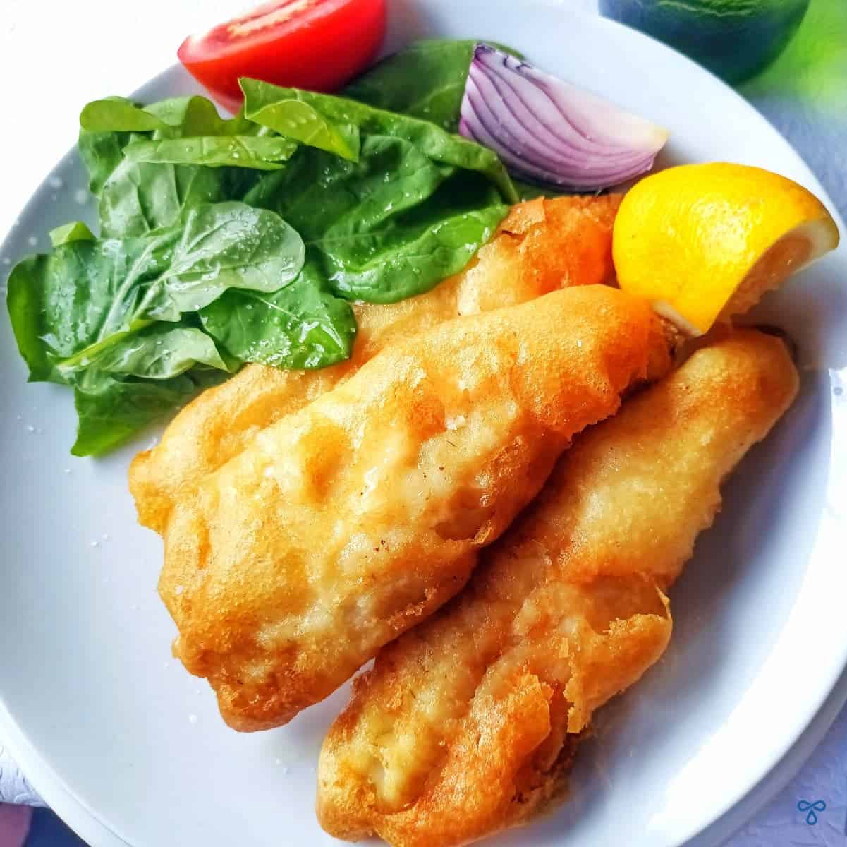 Deep fried battered zander served with rocket leaves, tomato, lemon and red onion.