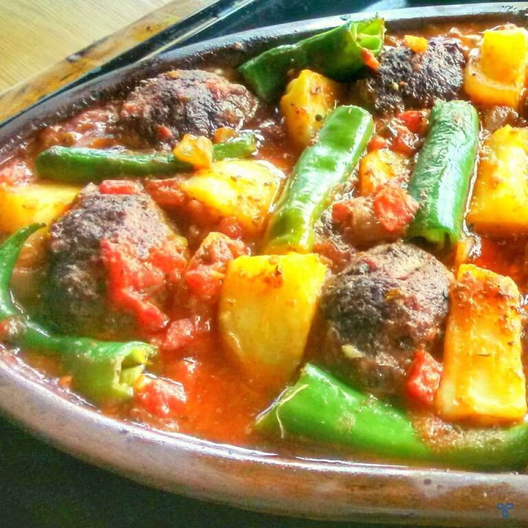 Meatballs in tomato sauce with cooked potatoes and green peppers