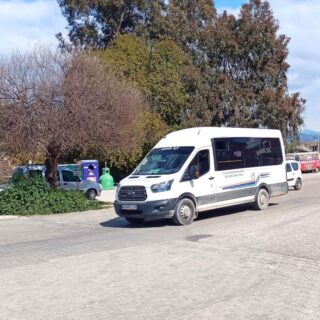 White Turkish dolmuş going along a tree-lined road
