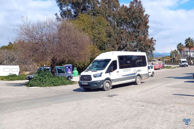 White Turkish dolmuş going along a tree-lined road