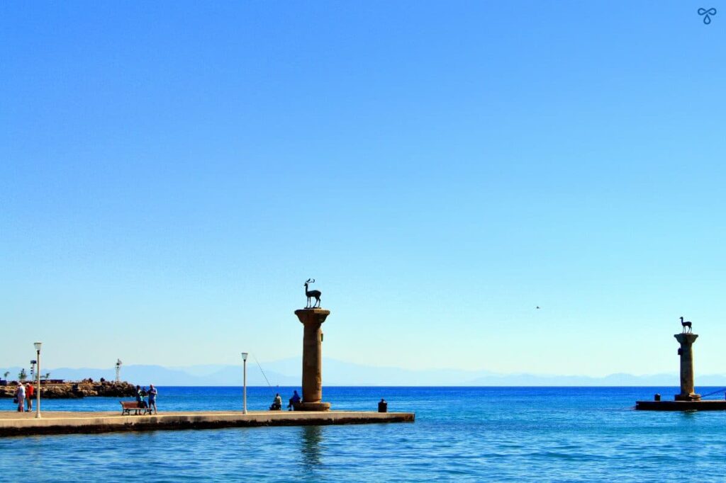 Two stone columns mark the entrance to the harbour in Rhodes, thought to be the site of the Colossus of Rhodes. A deer sculpture stands atop each column.