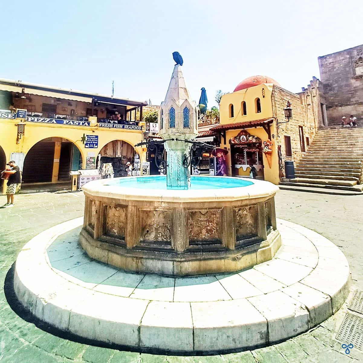 The circular stone fountain at the centre of Hippocrates Square in Rhodes Old Town.