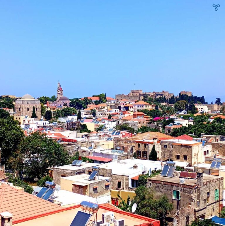 A view over the rooftops of Rhodes Old Town. The Place of the Grand Master is visible on the skyline.