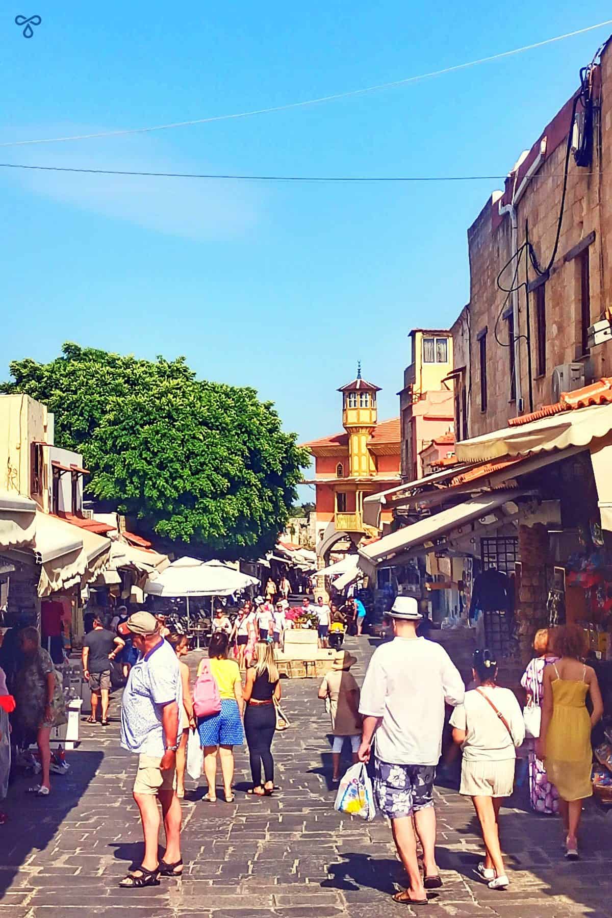 Shoppers along the slope of Socrates Street in Rhodes Old Town.