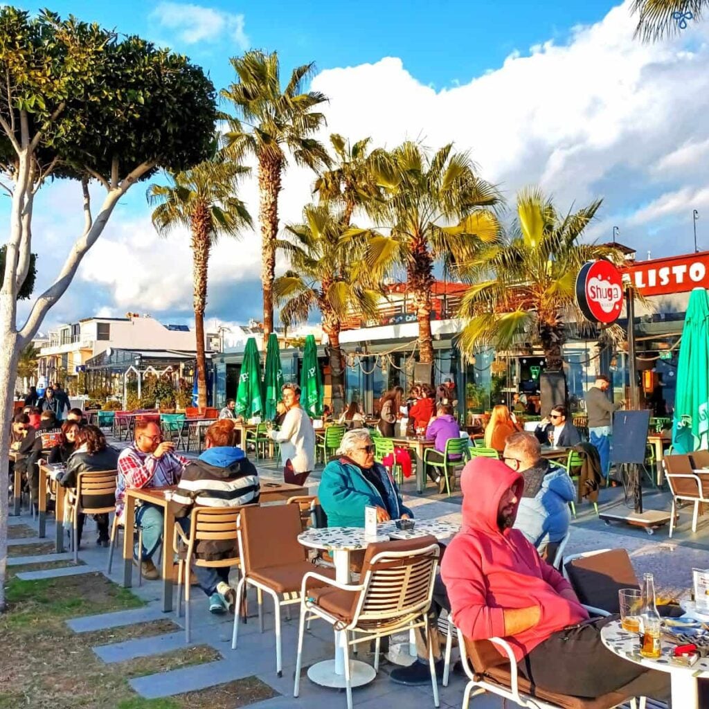 Locals Sitting Outside Calisto Pizza Restaurant In Winter