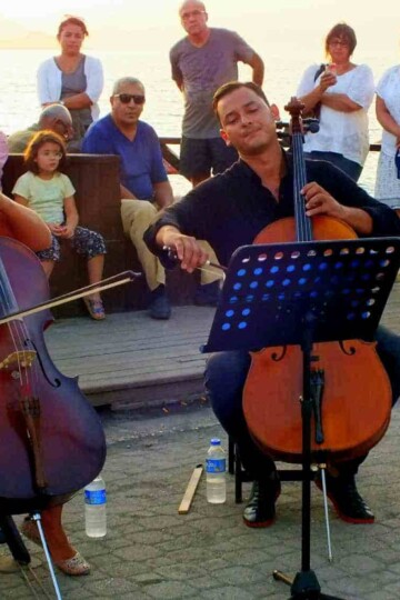 Two cellists do a sunset recital at Çalış Beach in Fethiye