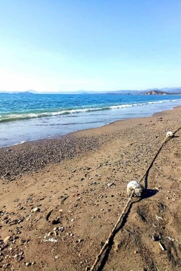 Sand Çalış Beach in winter. The sea laps the shore to the left.