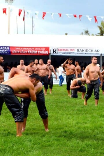 A group of Turkish oil wrestlers greet the crowd