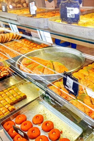 A variety of baklava in a glass display