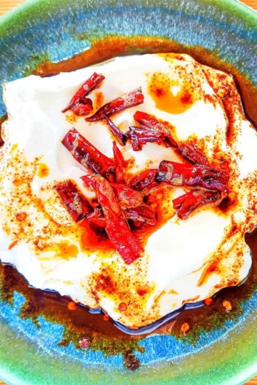 Natural yoghurt topped with dried red chillies and chilli oil.