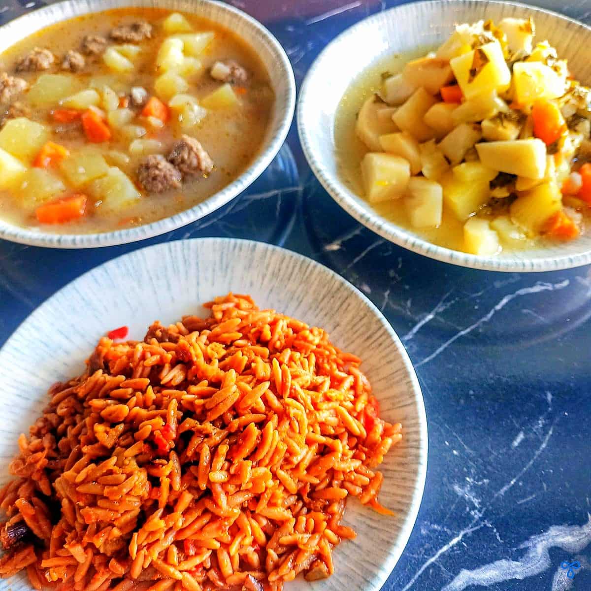 Three bowls filled with stews and and orzo.