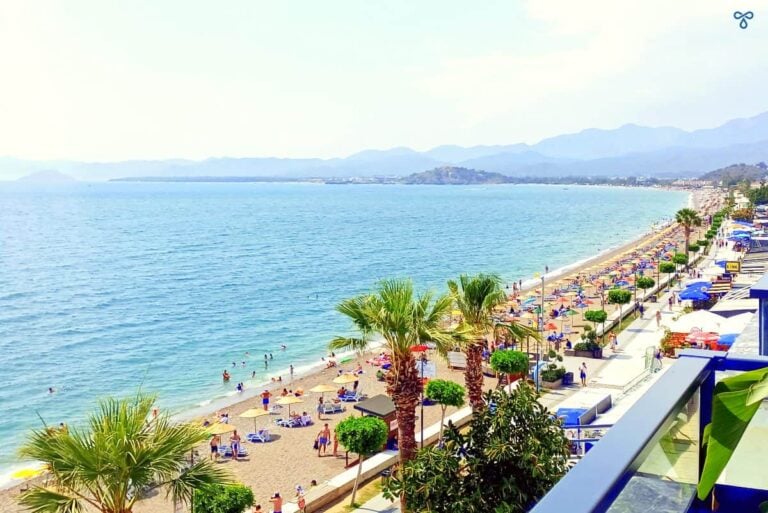 A view along the stretch of Çalış Beach from high up on Roof Bar. Sun loungers and parasols are along the beach.