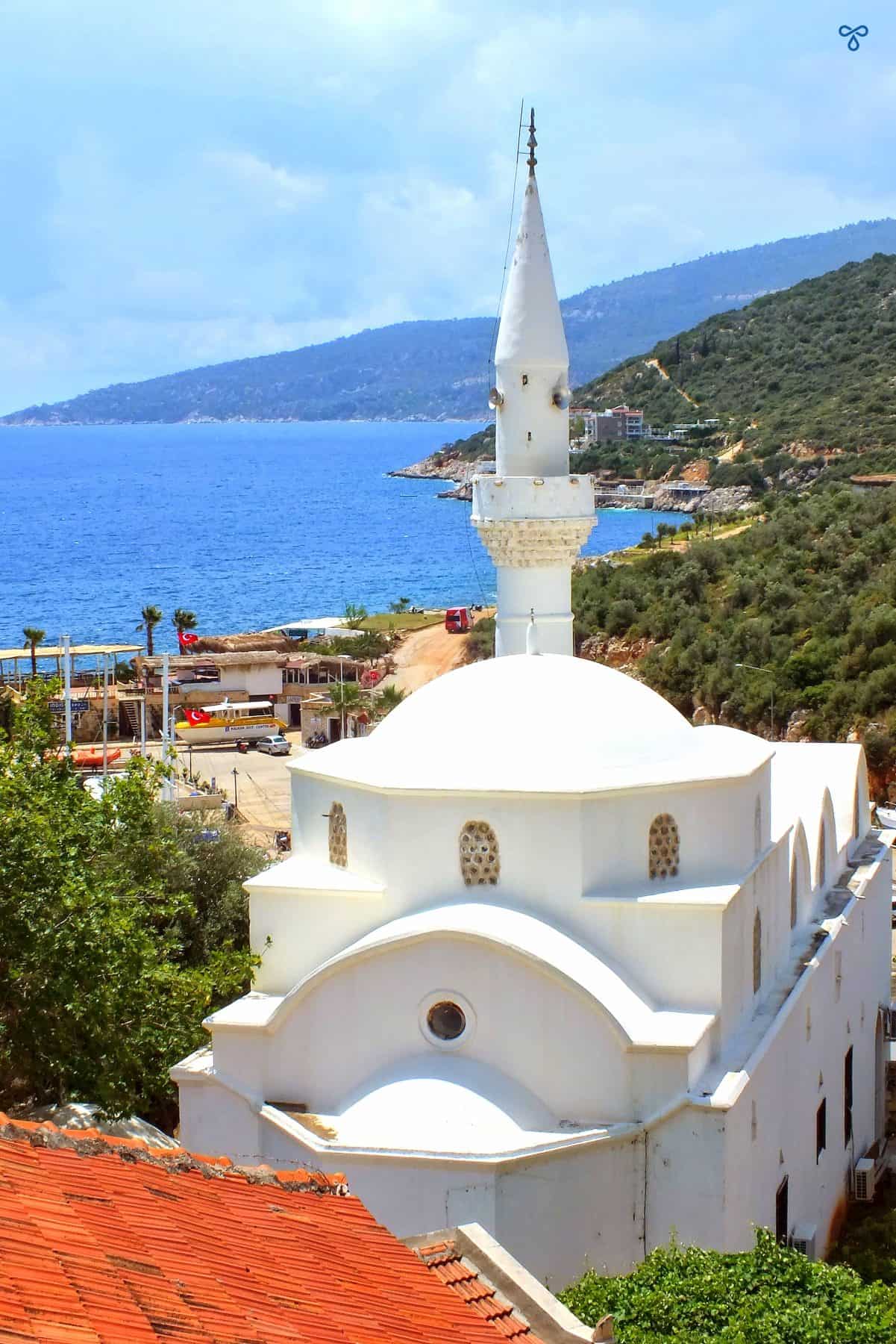 A whitewashed mosque with the sea in the background in Kalkan.