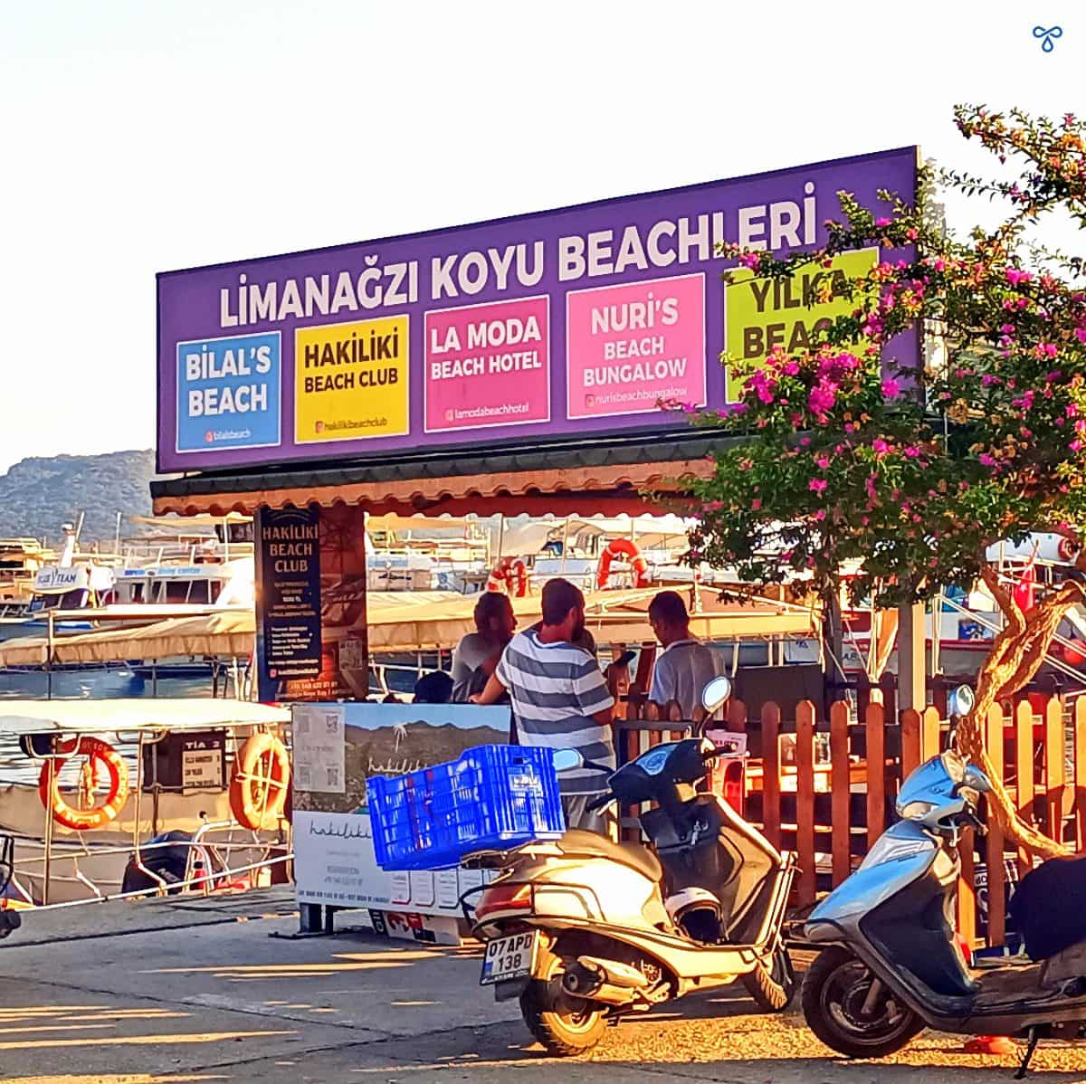 A kiosk on Kaş harbour showing their services to Limanağzı Bay beach clubs.