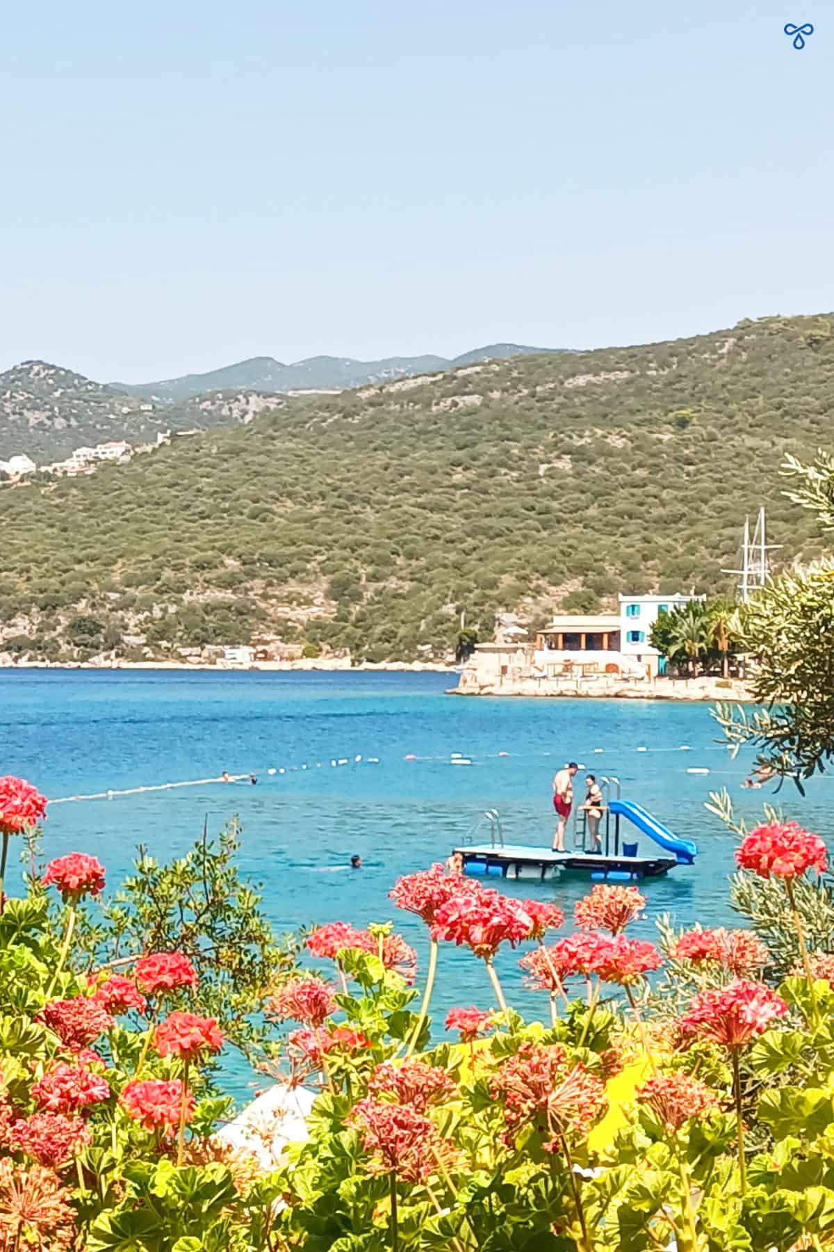 Children on a floating platform at Limanağzı Bay. Geraniums are in the foreground.