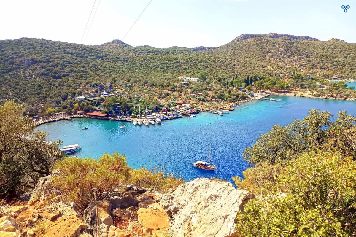 A view of Limanağzı Bay from the hillside above. The bay is surrounded by forested hills.