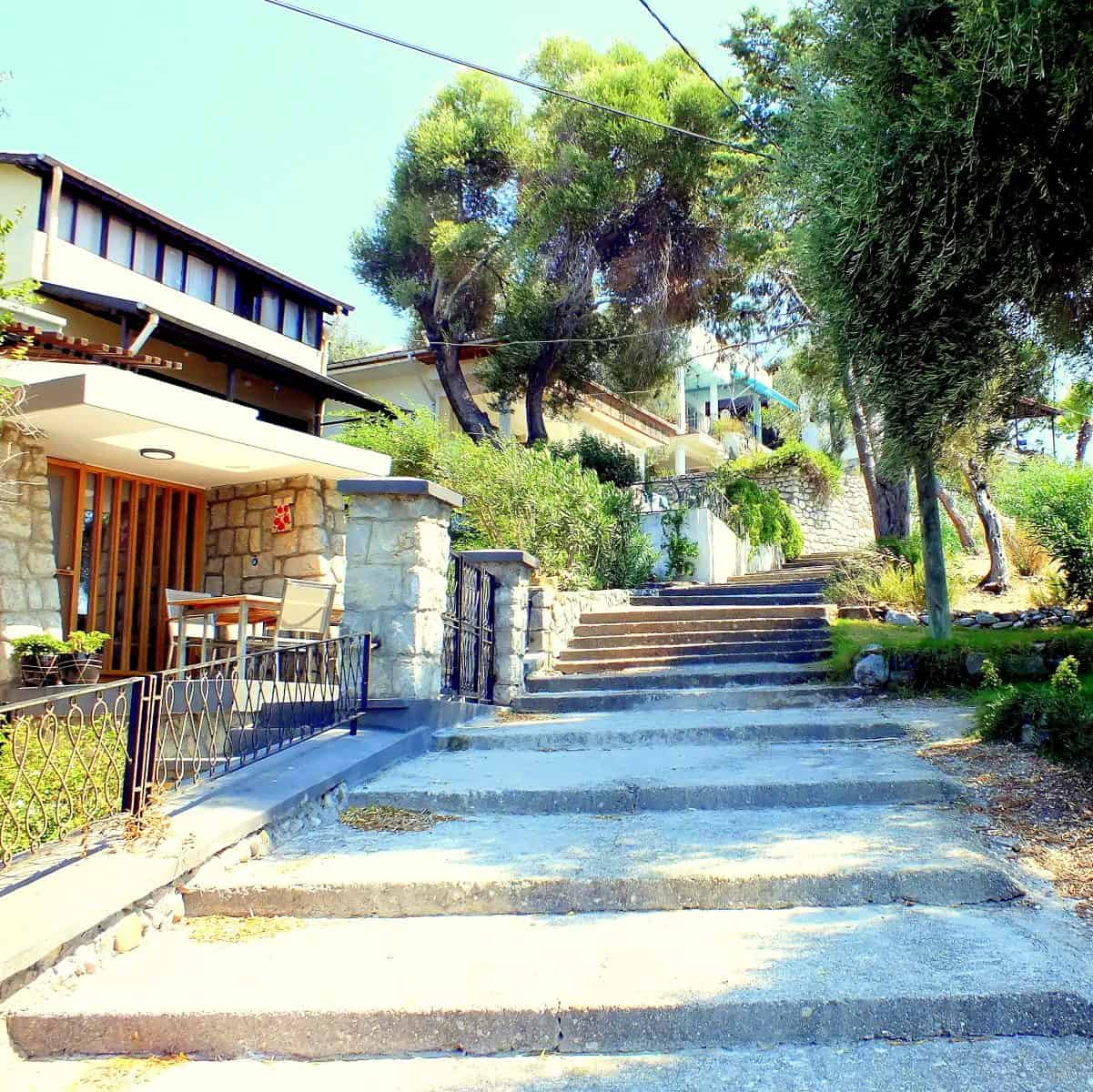 A hilly tree-lined pathway with shallow steps on Şövalye Island.