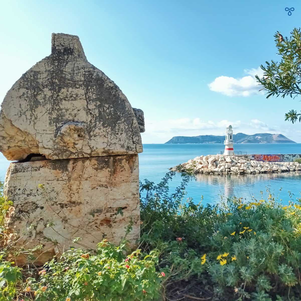 A Lycian rock tomb overlooking the harbour and lighthouse in Kaş.