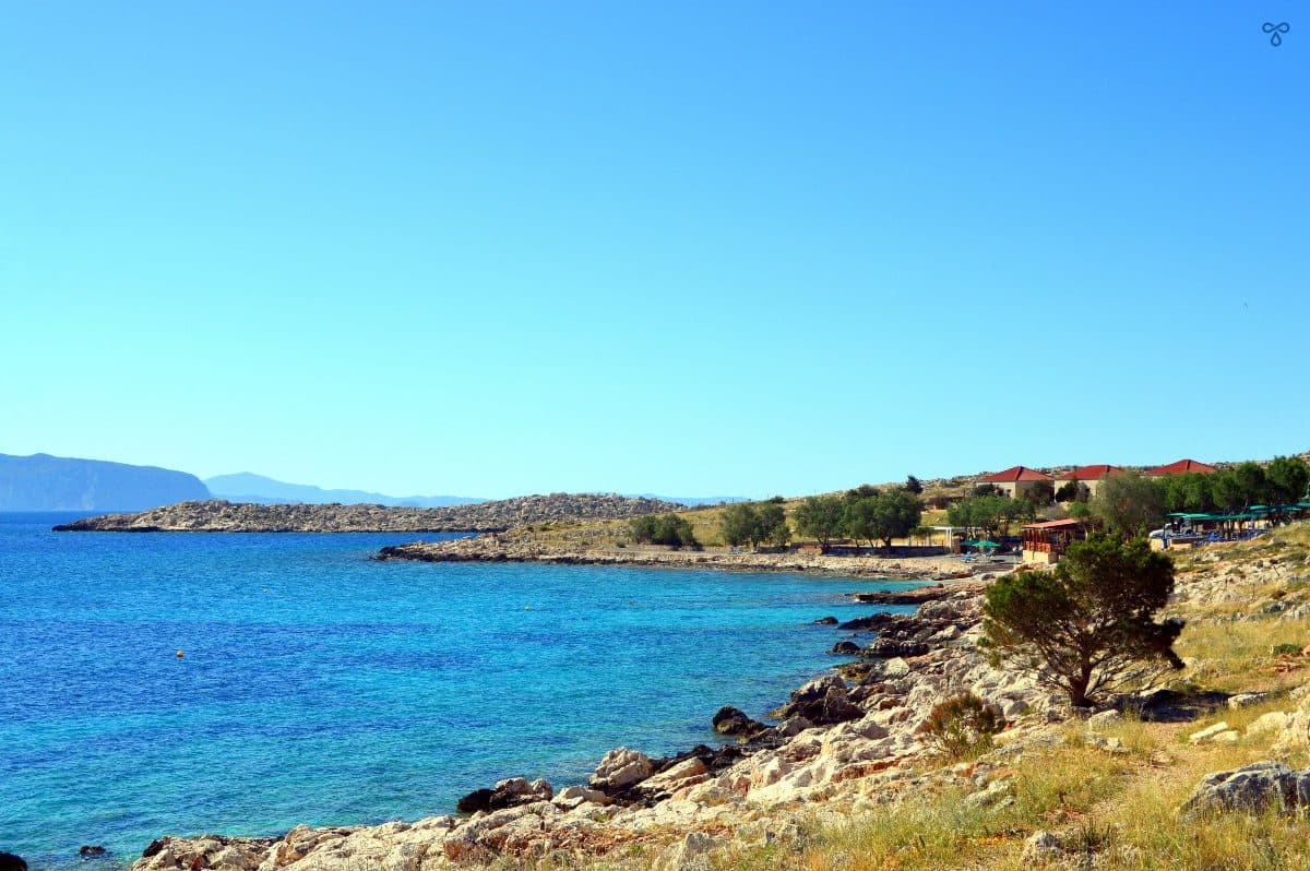 Halki coastline. The sea is on the left and the gently-sloped grassy lands are on the right.
