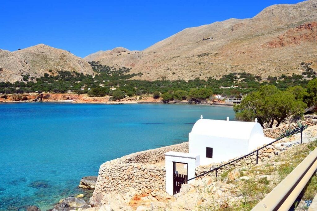 A whitewashed chapel overlooking a bay on the Greek island of Halki.