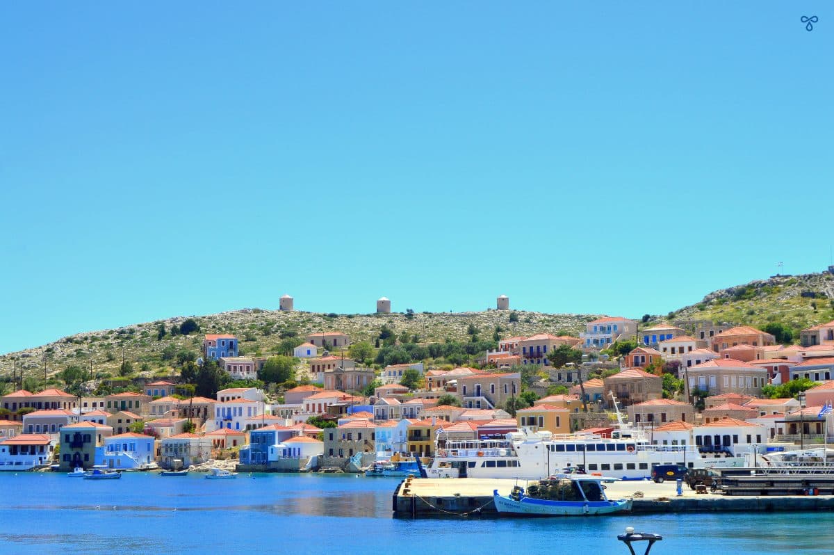 Looking over the harbour to the hillside topped with three windmills.
