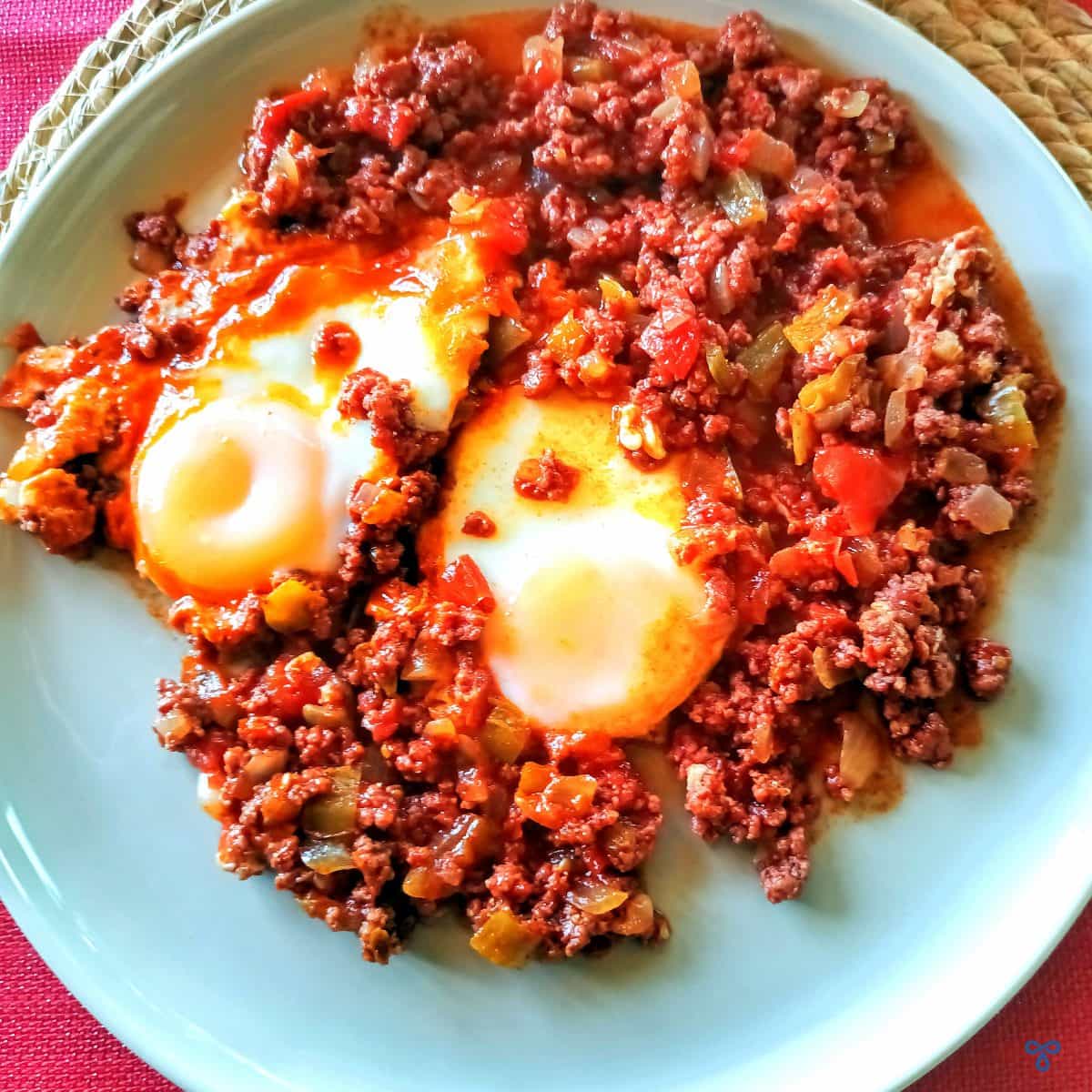 A plate of Turkish minced beef and poached eggs taken from above.