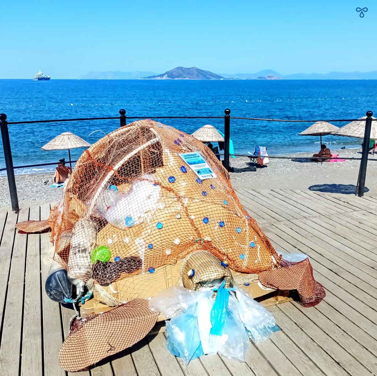 A cardboard sculpture of a sea turtle with bits of recyclable rubbish stuck to it to highlight the importance of looking after nature.