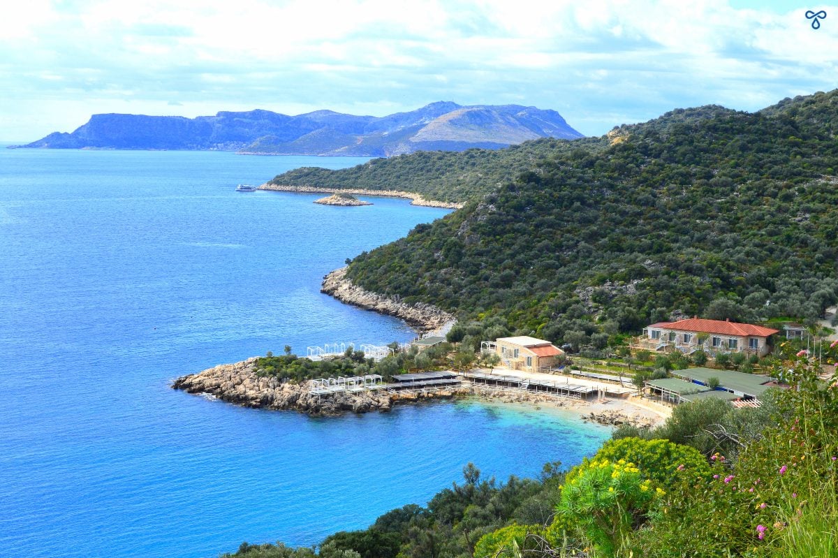Looking down on Hidayet Bay from the Kaş peninsula road. The hills are covered with trees and the Greek island of Kastellorizo is in the near distance.